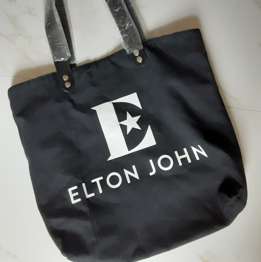 Black bag Elton John name on it. Strong durable canvas material shoulder straps.